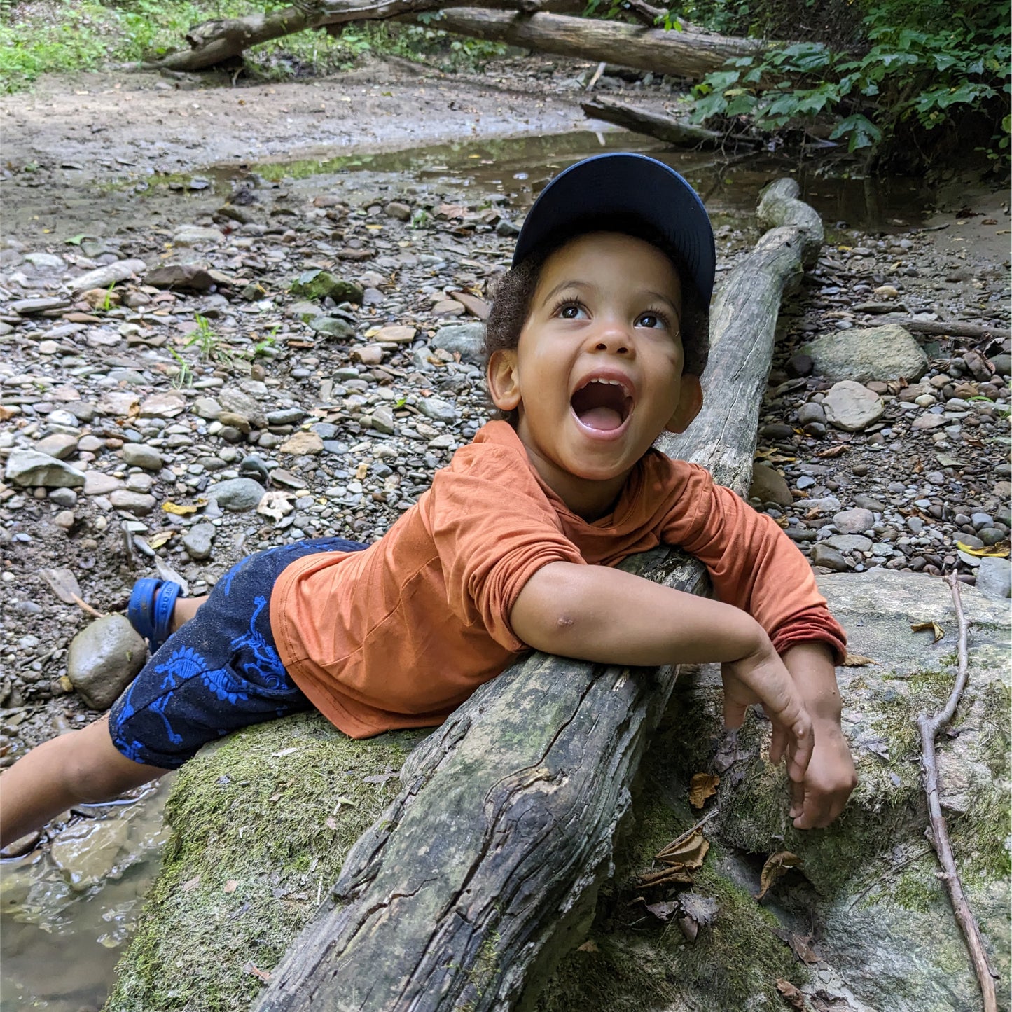 A kid enjoying an afternoon at the creek. Playing and splashing in nature