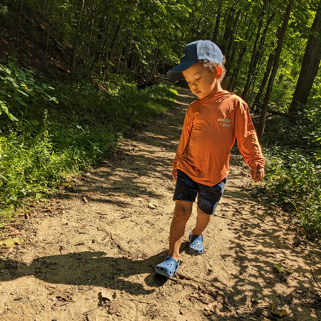 Child wearing muddy and mind ONE shirt for sun safety UPF 50+