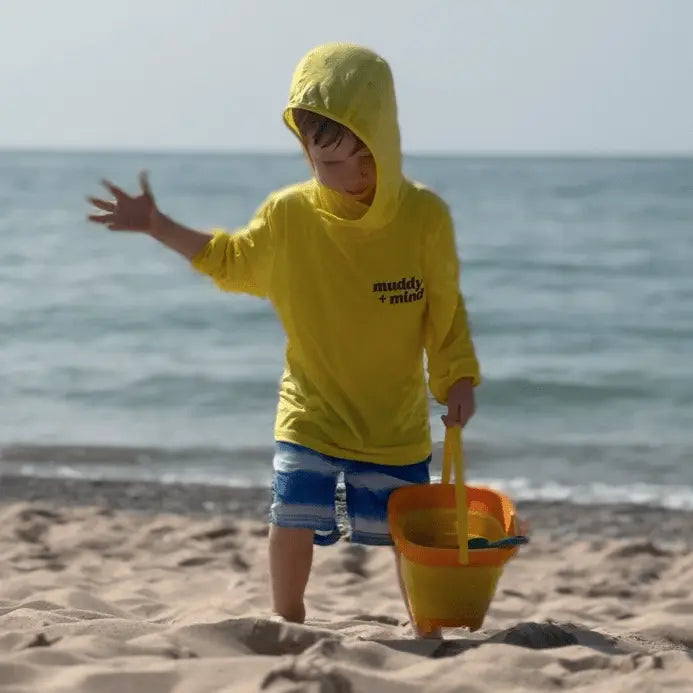 kis playing at the beach with the safety yellow ONE shirt by Play Outside