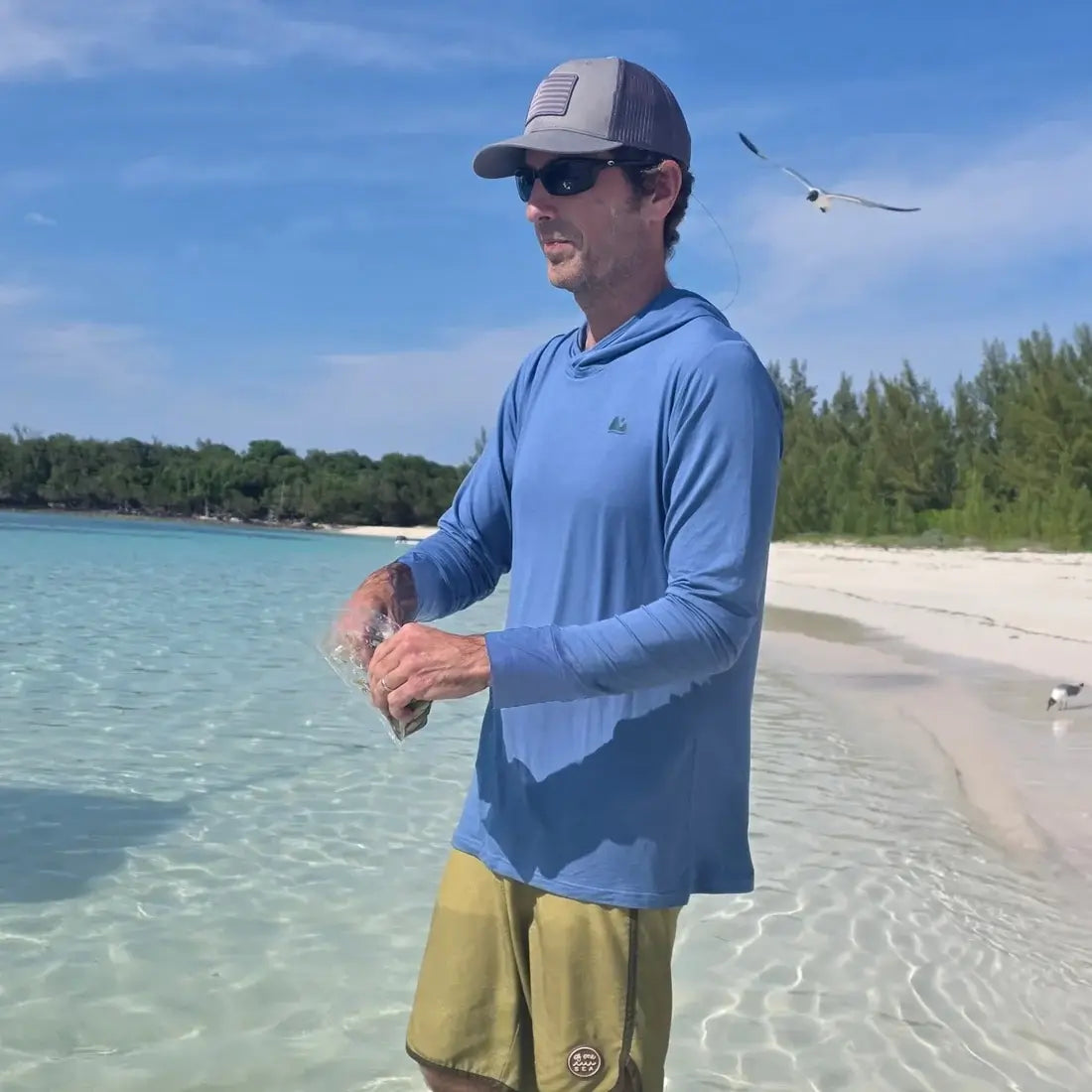 man with blue sun shirt at beach