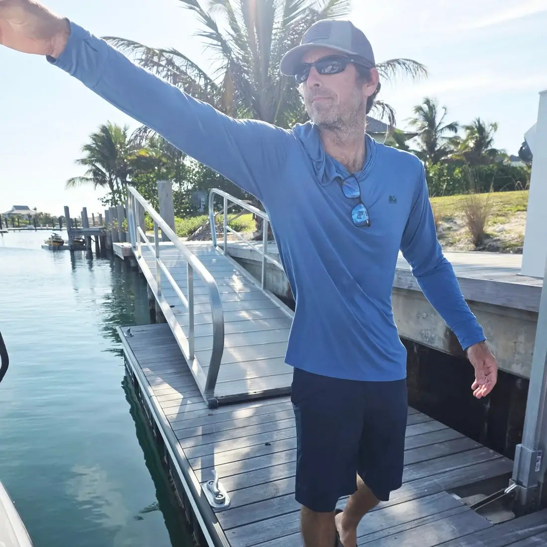 man wearing sun shirt on dock