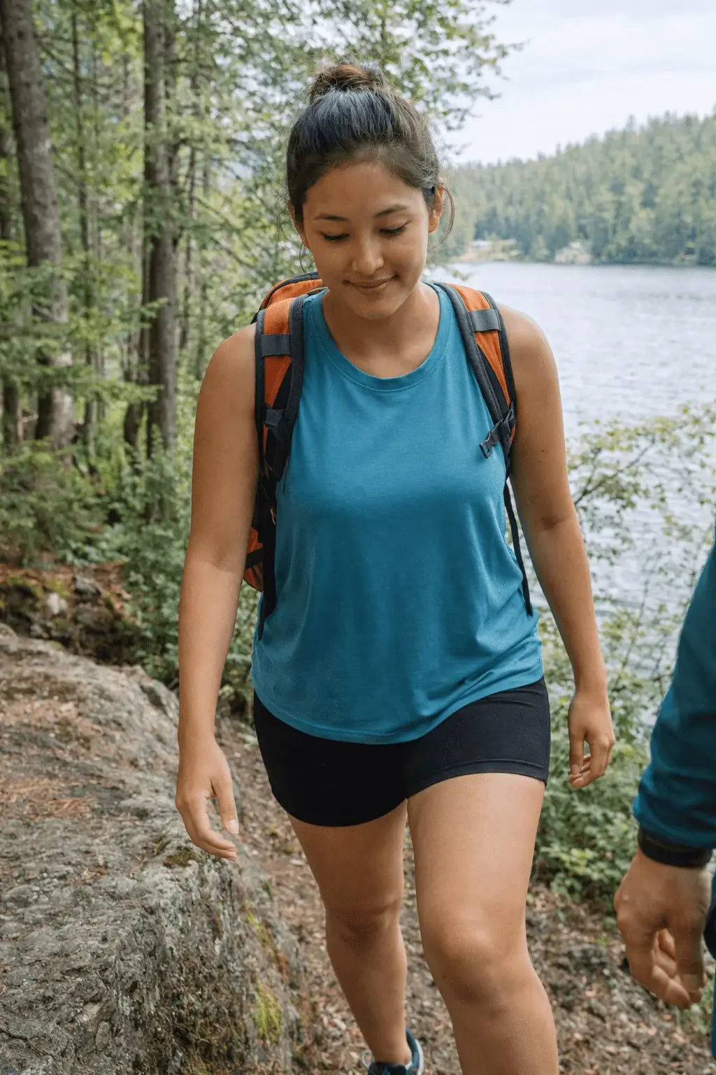 woman hiking wearing ALL tank