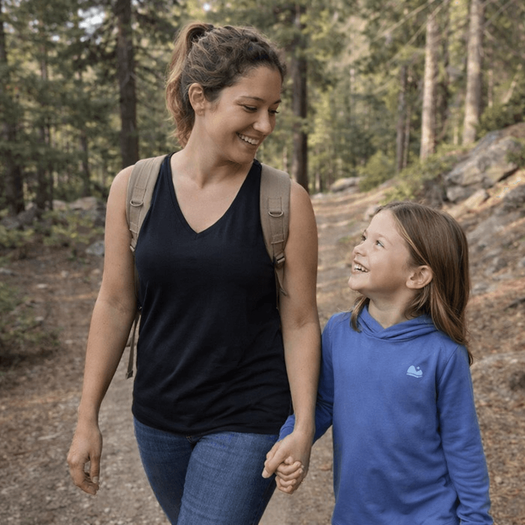 mom and girl hiking in the woods