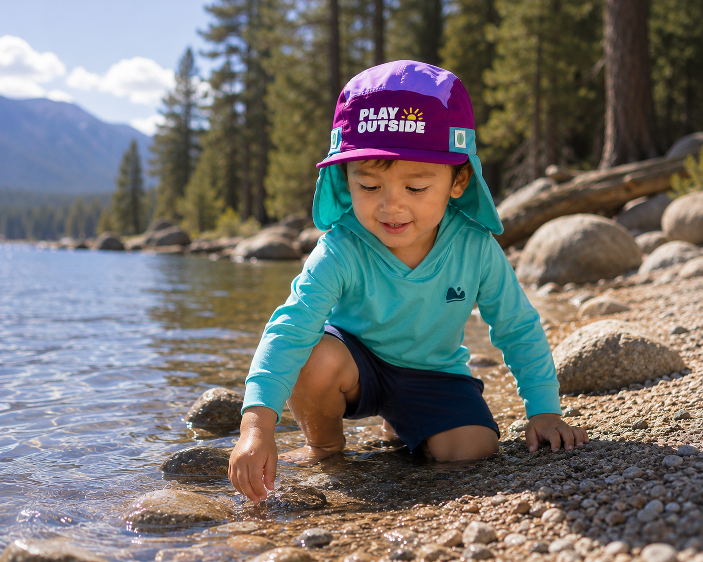 kid playing in a creek wearing sun hat and sun shirt