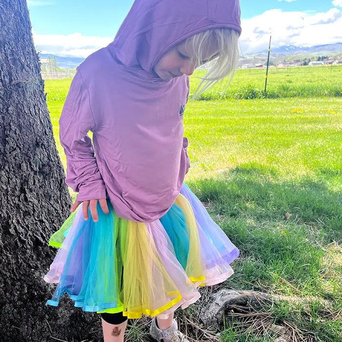 girl in pink sun safe shirt playing outdoors