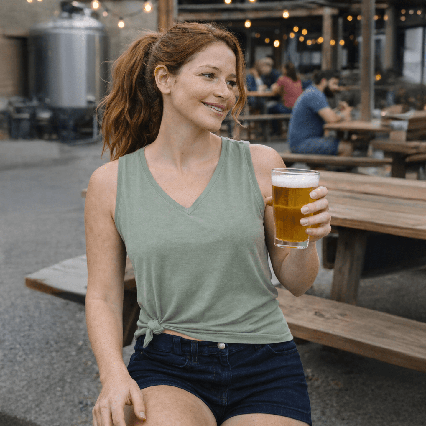 woman wearing the green FLEX top at a brewery