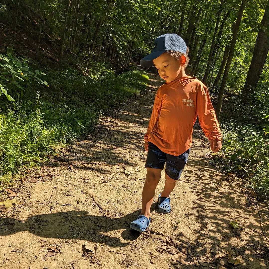 Child wearing muddy and mind ONE shirt for sun safety UPF 50+