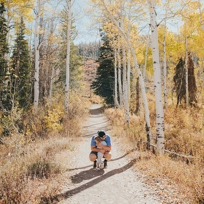 dad and kid hiking on a crips fall day