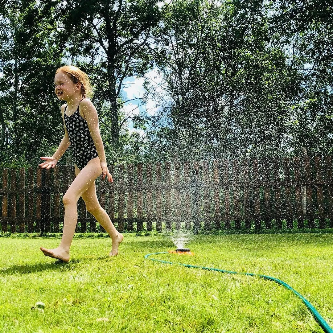 gild playing in the backyard on a hot summer day