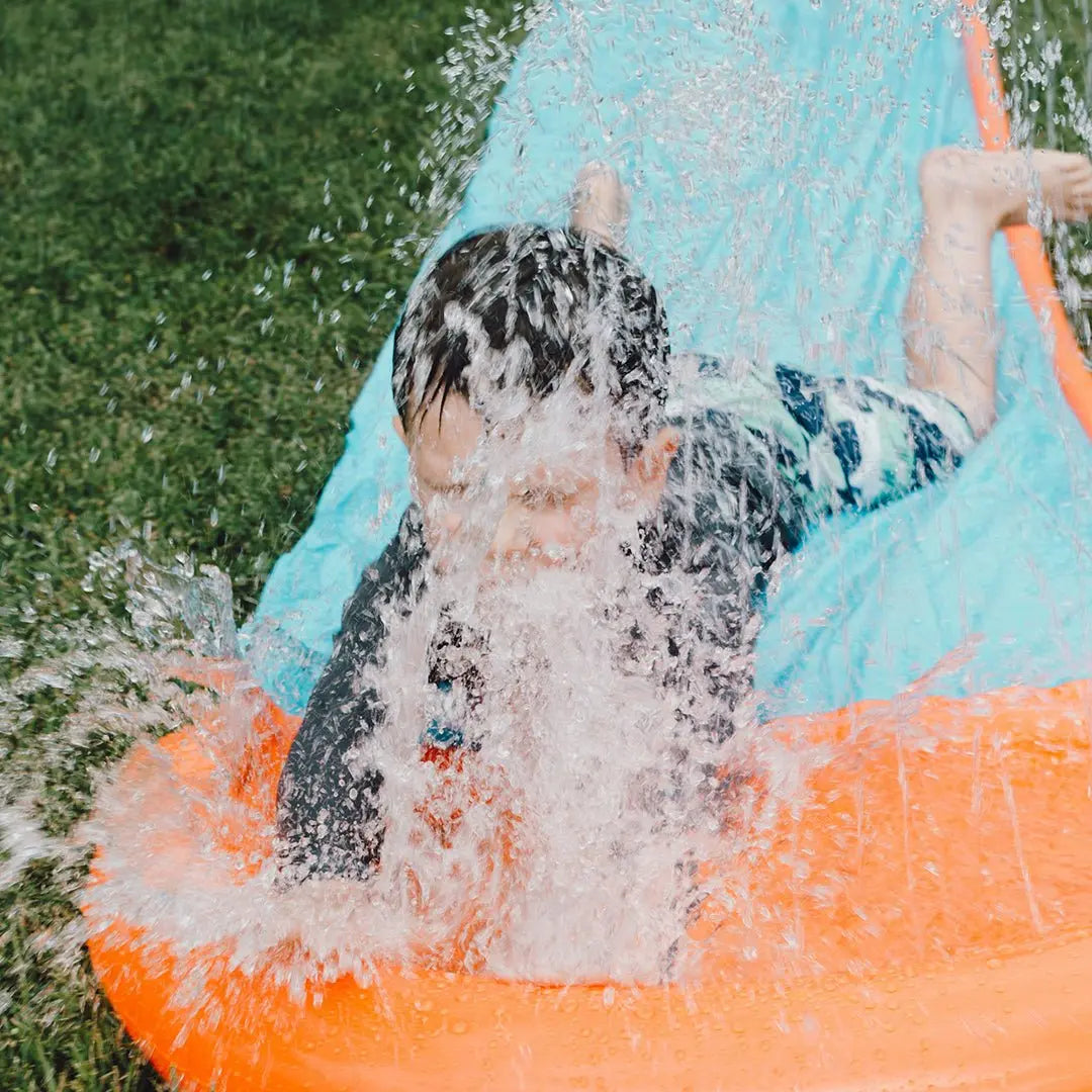 Kid splashing in backyard