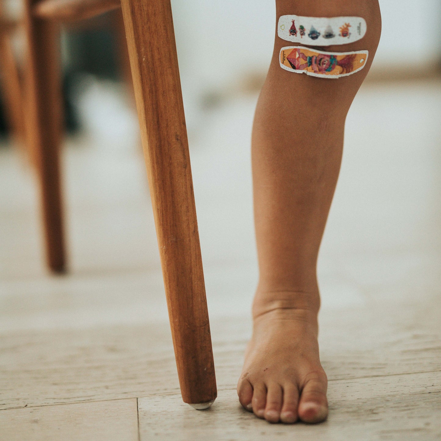 kid with bandaids on his knees