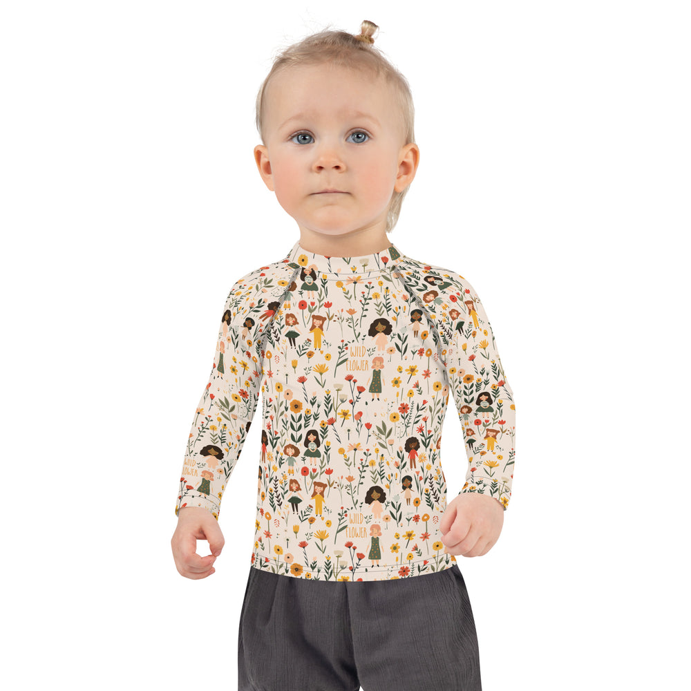 A kids’ rash guard featuring detailed wildflower patterns, perfect for protecting sensitive skin while enjoying the outdoors.