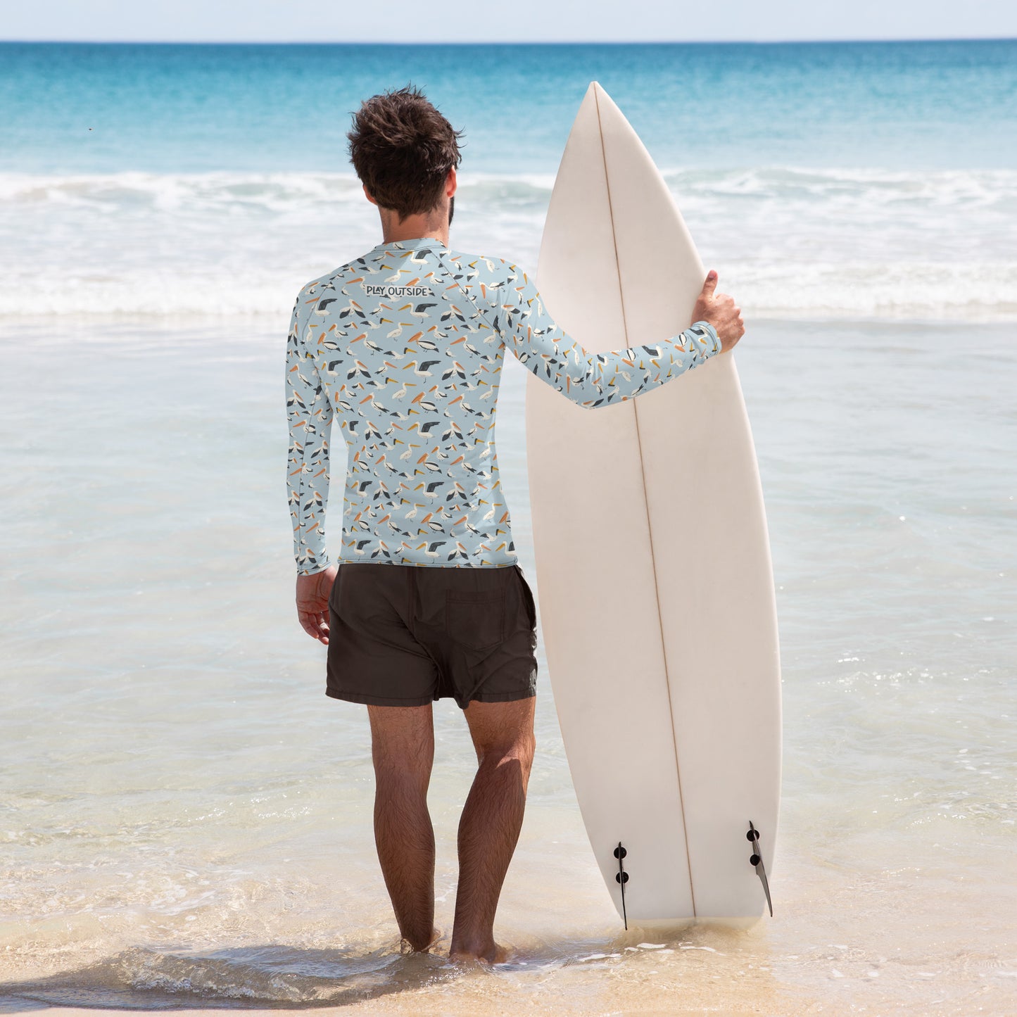 A sustainable pelican-themed men’s rash guard, designed for surfing, fishing, or exploring the outdoors, with UPF 50+ protection. Family Matching