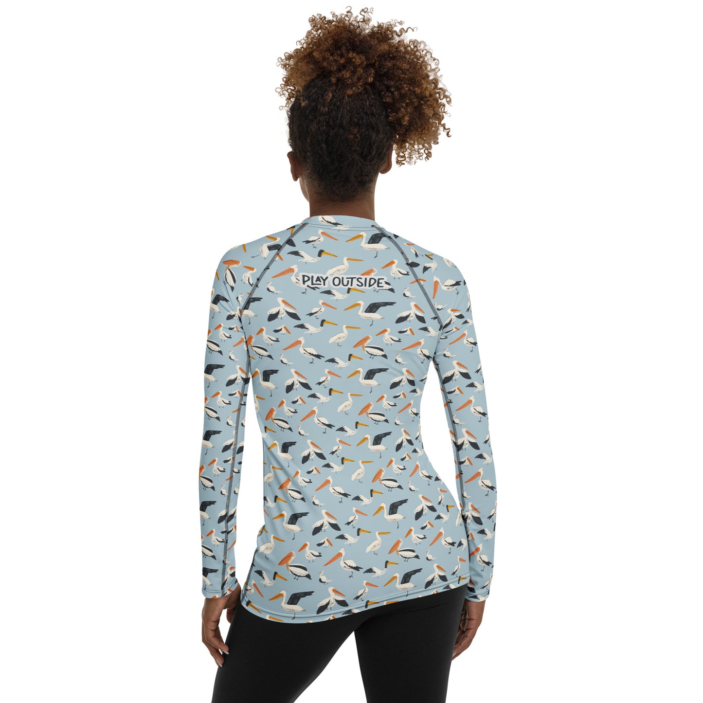 A women’s pelican-print rash guard, shown from the back with a coastal-inspired design for sun-safe fun.