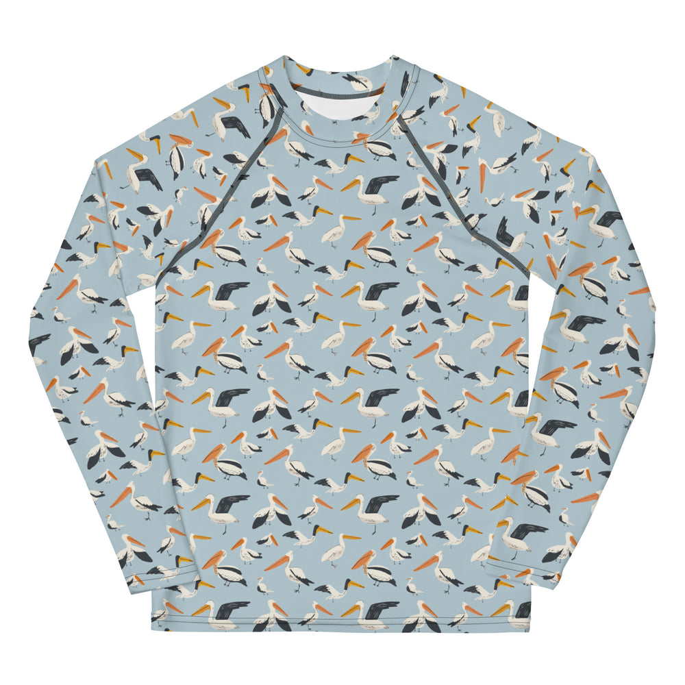 A teen’s rash guard featuring a playful pelican print with shades of blue and white, shown from the front.
