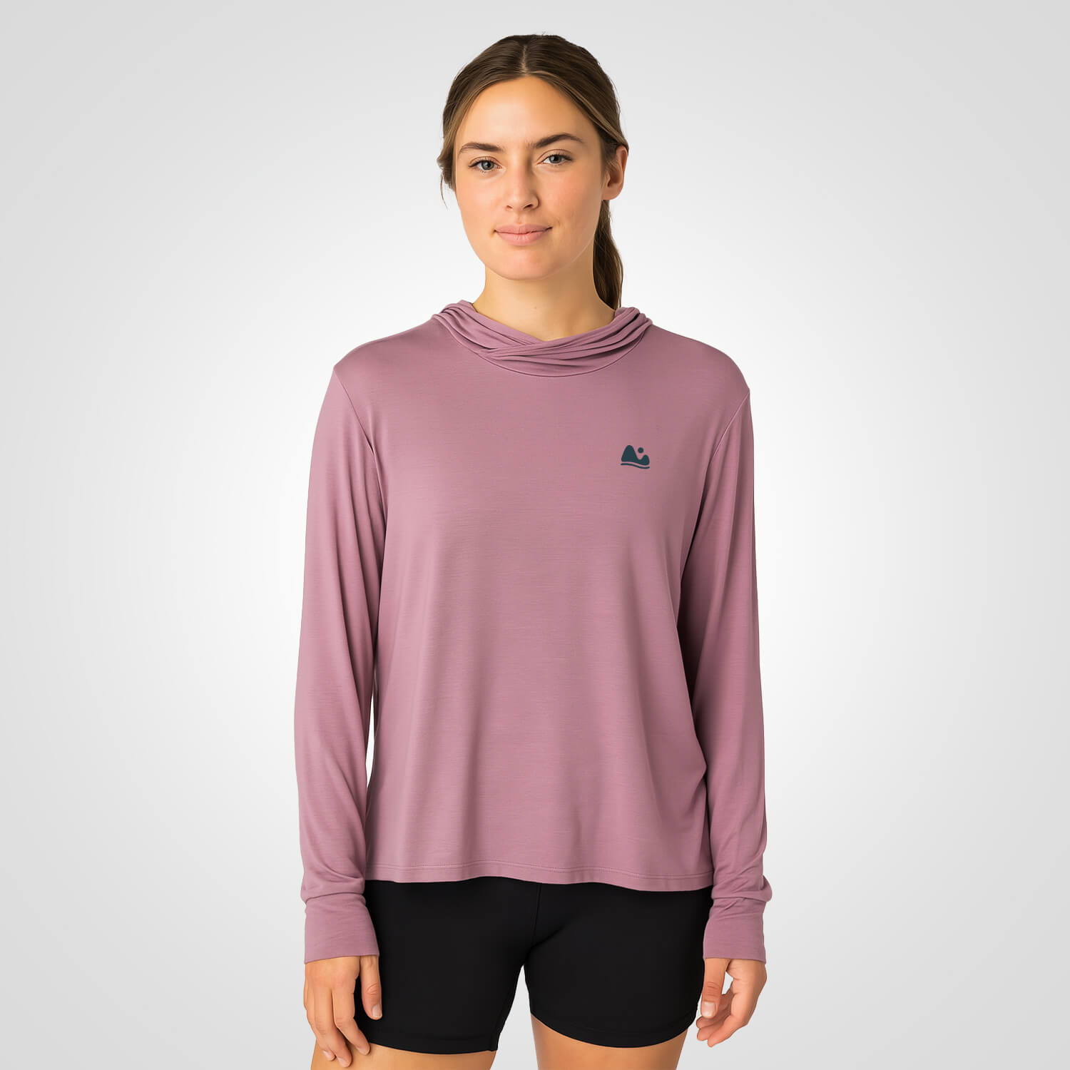 Woman wearing pink bamboo sun shirt UPF ONE shirt and base layer