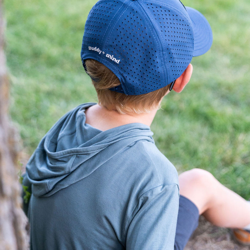 
                      
                        Close-up of The ONE Shirt in Teal, featuring a sun-protective hood and thumb holes for secure layering.
                      
                    