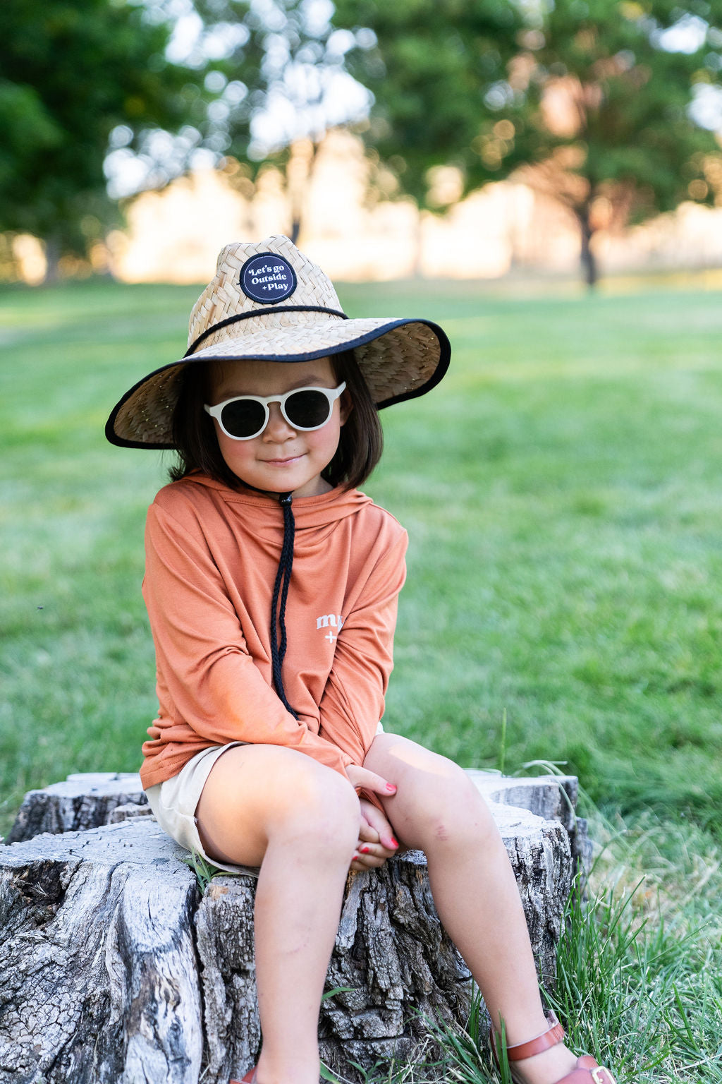 Child exploring the outdoors in The ONE Shirt Terracotta, a versatile bamboo shirt designed for comfort in every season. Wearing the Muddy + Mind straw hat