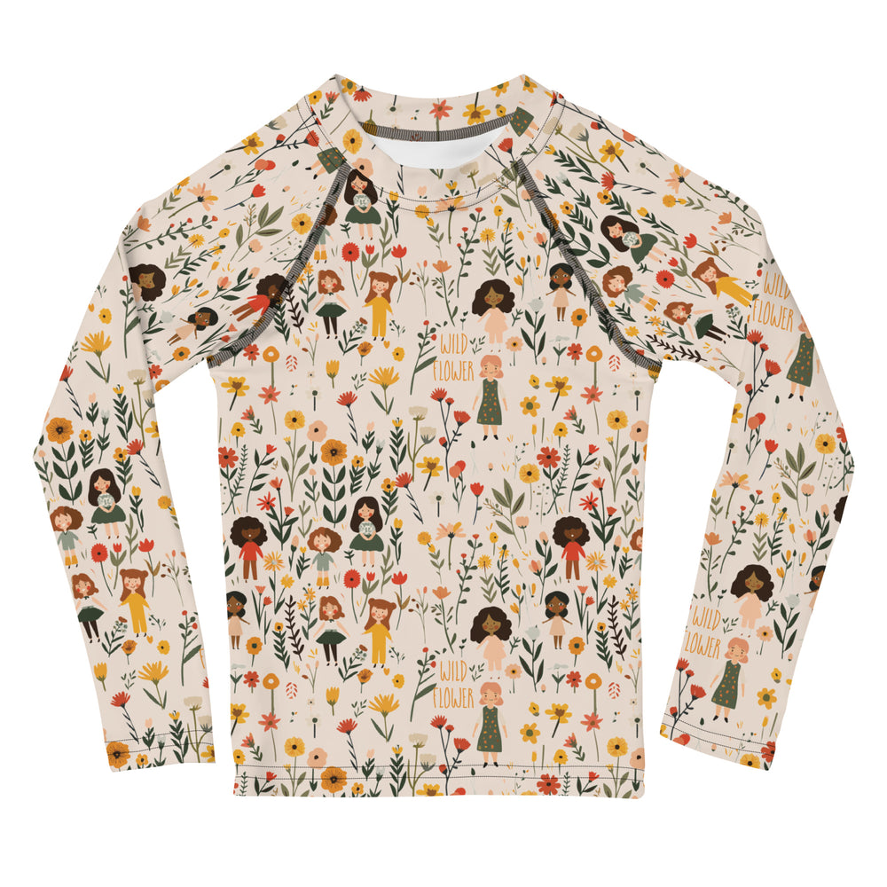 A flat lay of a wildflower-themed rash guard, showcasing the intricate floral and girls pattern