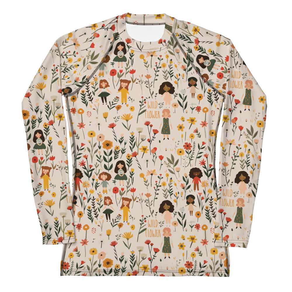 A women’s rash guard featuring a detailed wildflower print in earthy tones, shown from the front.