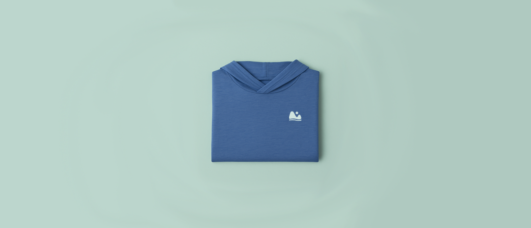 Blue ONE Shirt with a Play Outside logo on a light blue background for minimalist travel